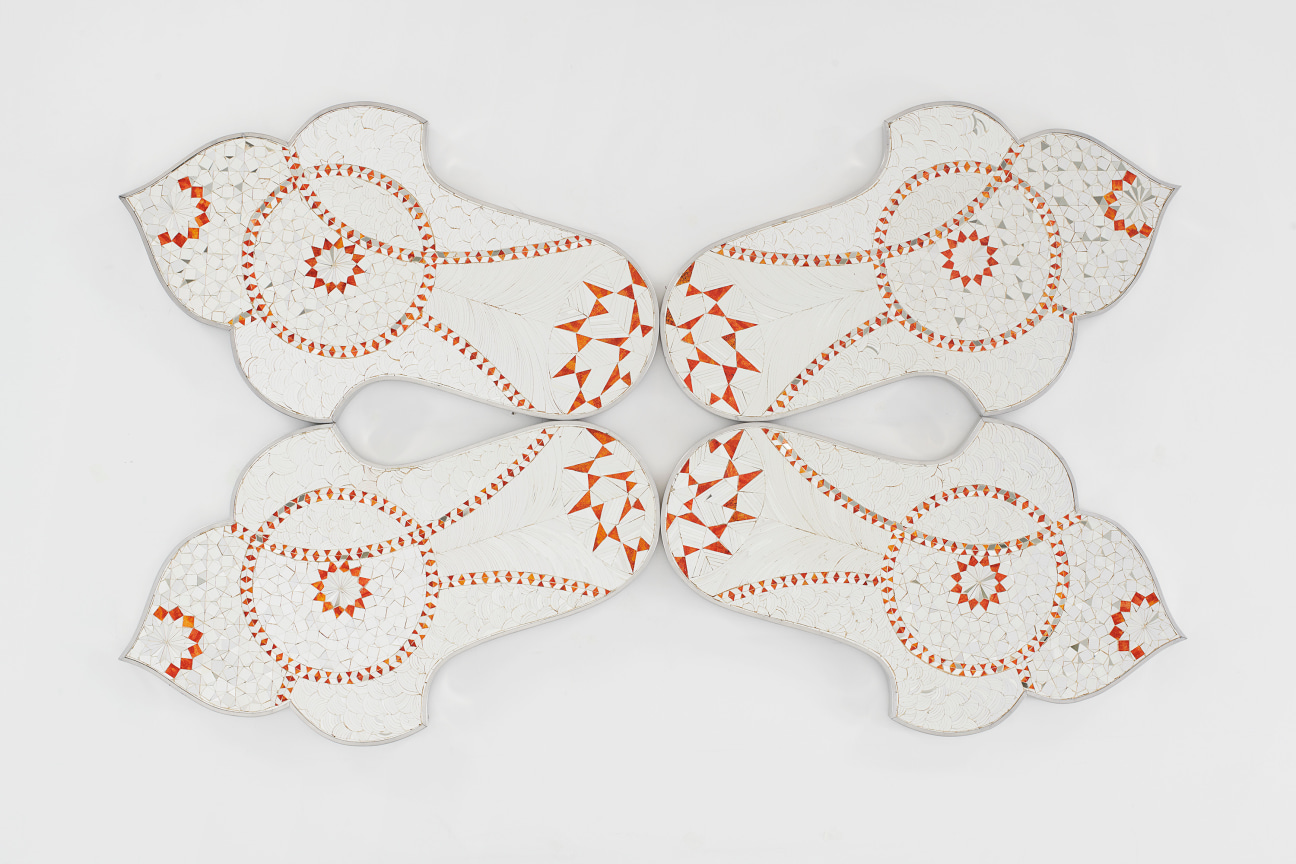 Geometric reverse mirror panel with painted details mounted to a wall by Monir Shahroudy Farmanfarmaian.