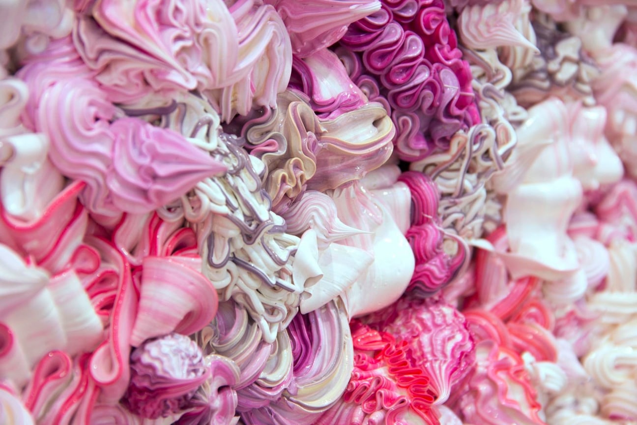 dollops of pink, purple, and white whipped cream substances packed together