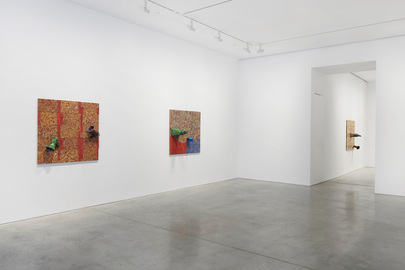 gallery view of two artworks with an entry way to another room on the right