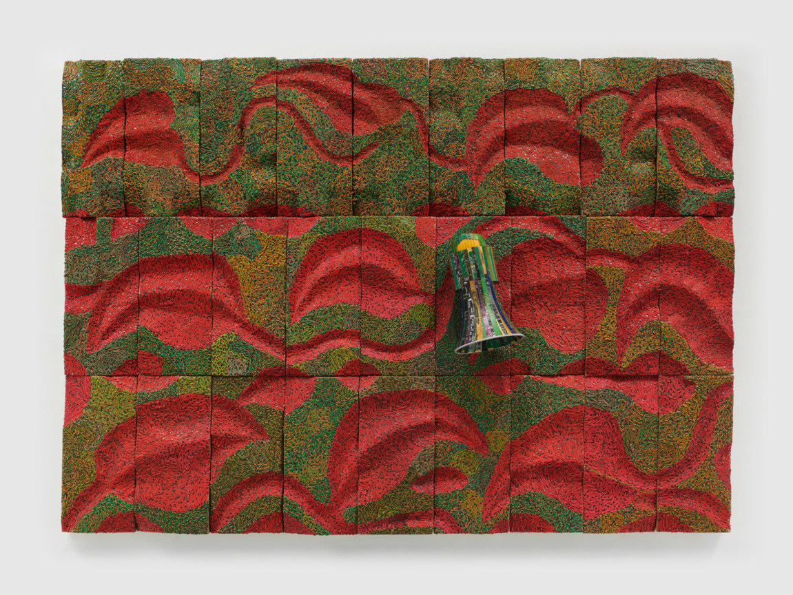 megaphone emerging from a surface contains a red leaf pattern