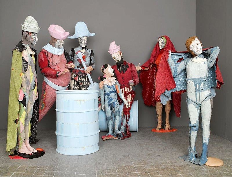 group of statues with content expressions on their faces