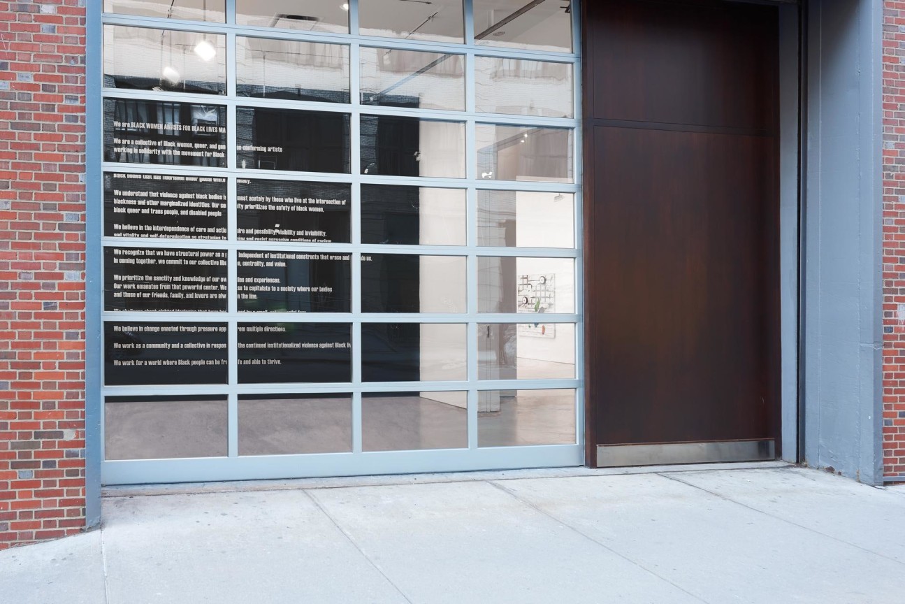 view of several artworks from the outside of the gallery