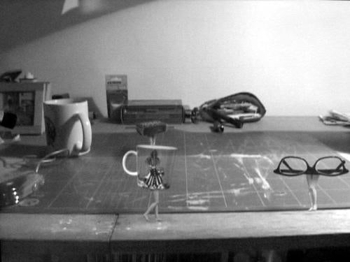tea cup and glasses with legs walking on counter top