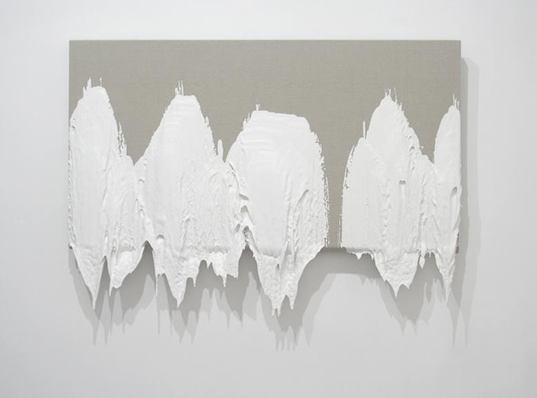 view of canvas dipped in thick, white paint