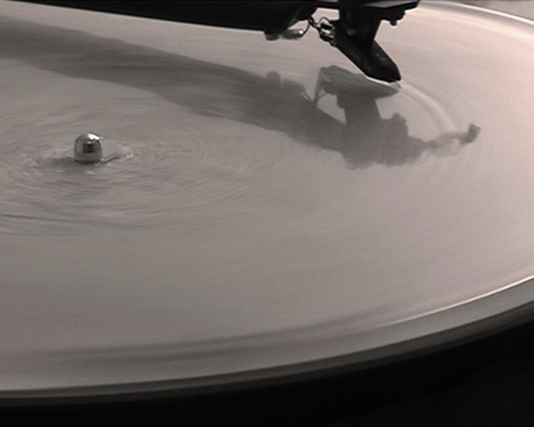clip of film showing a close-up of a spinning record on a record player