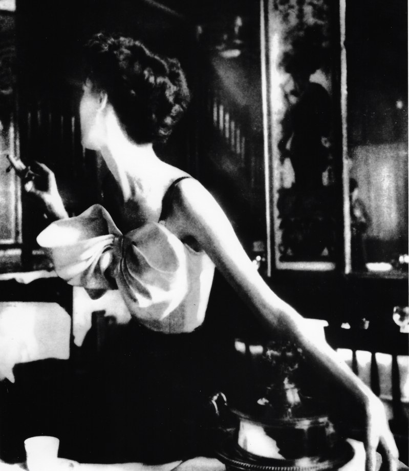 Lillian Bassman, Across the Restaurant: Barbara Mullen in a dress by Jacques Fath at Le Grand Vefour, Paris. Harper's Bazaar, 1949