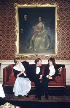 Slim Aarons, Pop and Society: Marianne Faithfull, Desmond Guinness, and Mick Jagger seated in conversation at Guinness's home Leixlip Castle in Ireland, 1968