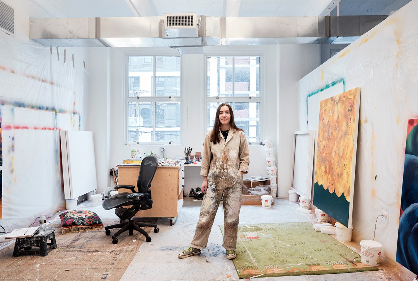 Artist Ana Benaroya standing in her studio