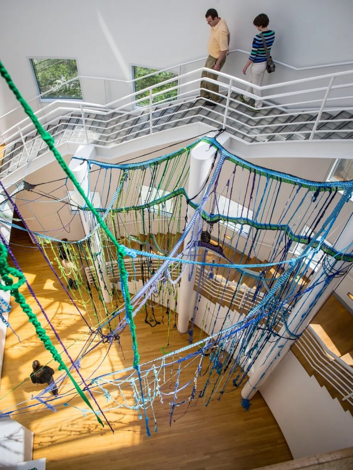 Patrons walk around the multi-story, &quot;Put Me Down Gently,&quot; 2014, by Sheila Pepe. Rodney White/The Register.