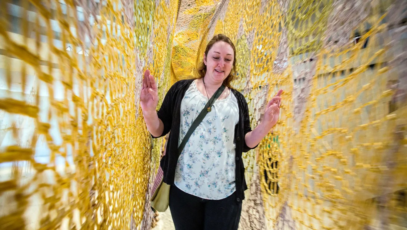Candice Rowland of Winterset walks through the interactive sculpture, &quot;SoundWay,&quot; 2012, by Ernesto Neto. Rodney White/The Register.