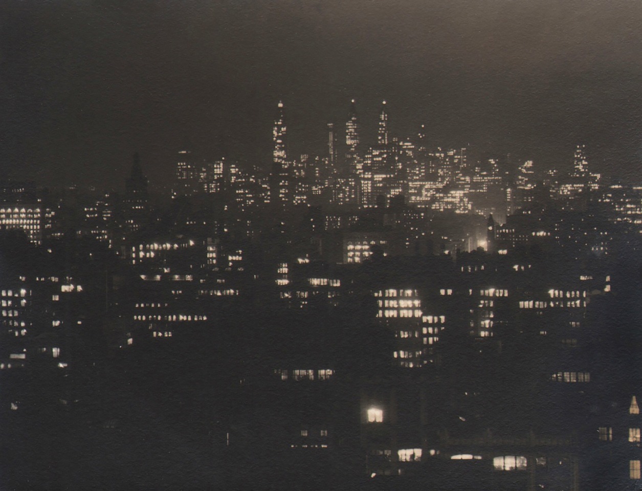 Paul J. Woolf, Untitled, ​c. 1935. Night time cityscape with tallest buildings in the background.