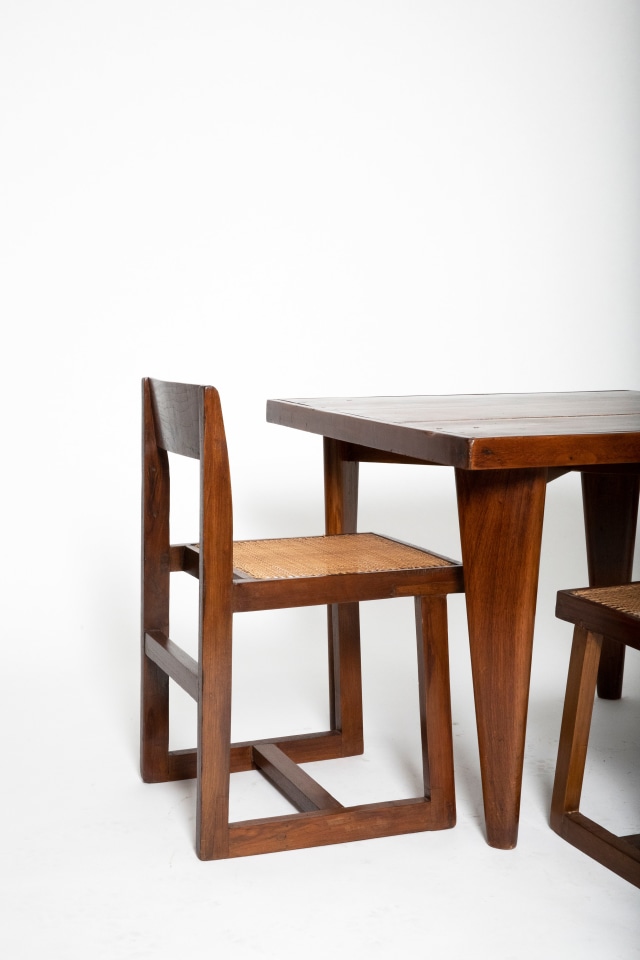 Close up view of Pierre Jeanneret's square table shown with set of 4 Jeanneret chairs