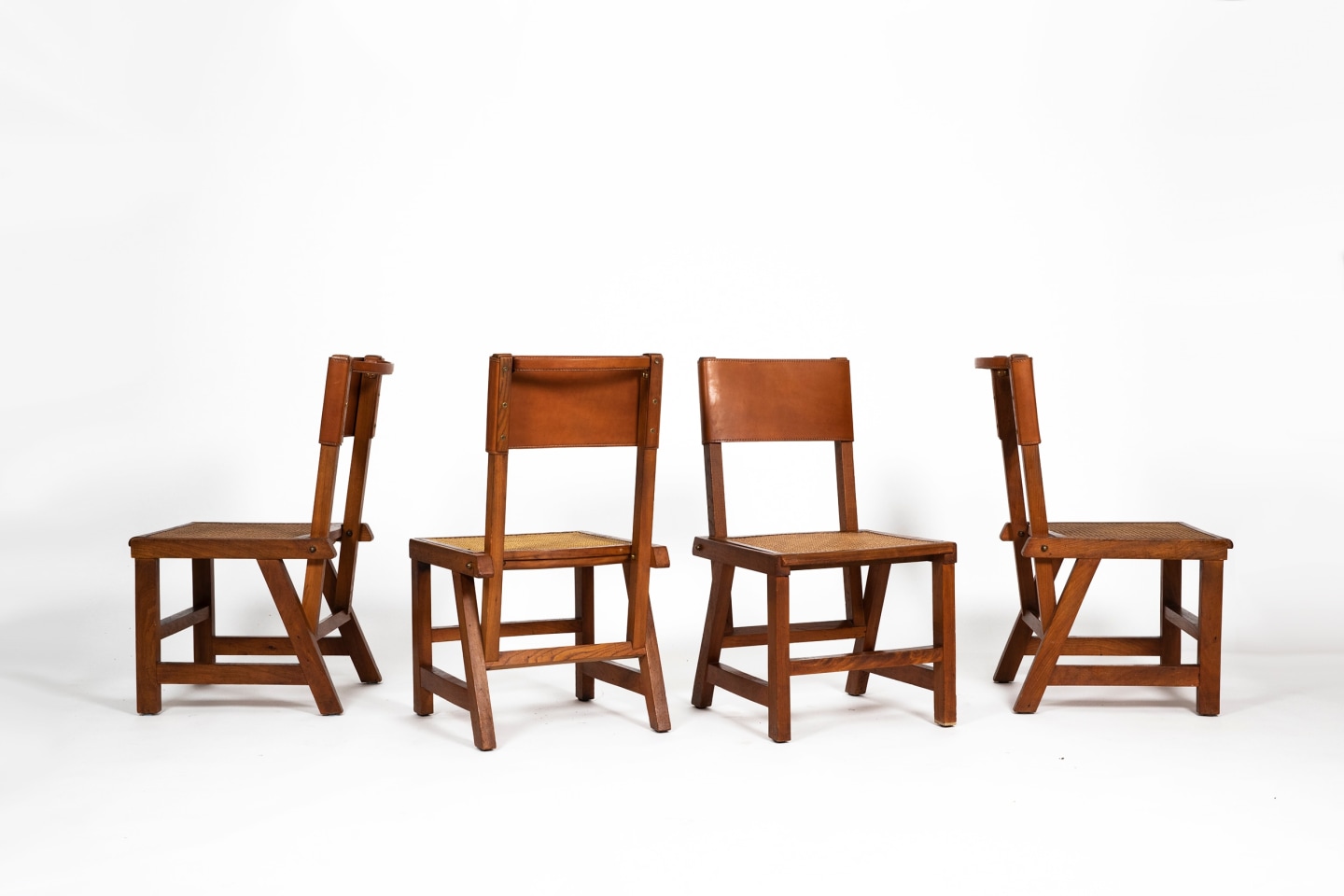 image of set of 4 chairs by Jacques Adnet