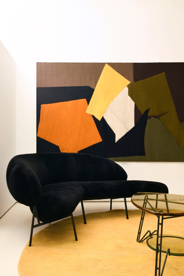 Michael Bargo's room | Pieces from top to bottom are Claude Stahly's tapestry (1970), Pierre Sz&eacute;kely's boomerang shaped sofa (1953), and an Italian side table (c. 1950)
