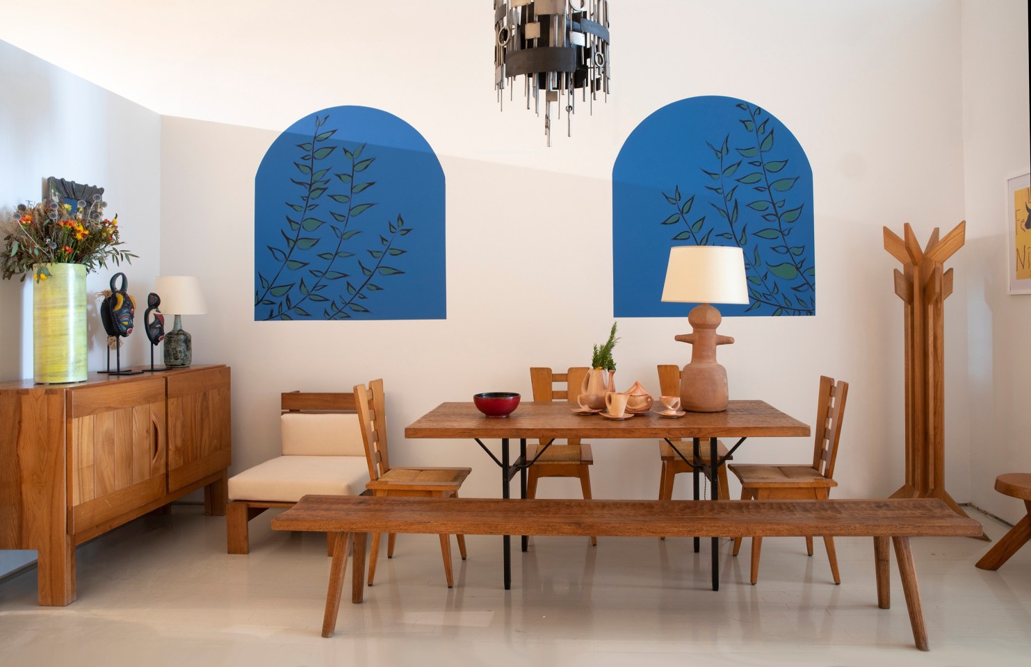 Installation view of exhibition. Pieces from left to right Maison Regain's sideboard, Georges Jouve's large vase, Jaques Sagan's ceramic mask, Jacques Blin's ceramic table lamp, an unattributed lounge chair, Marolles' bench and dining table, Henry Jacques Le M&ecirc;me set of 4 dining chairs, Georges Jouve's red bowl, Vallauris' tea set, Claude &amp; Jean Bersoux's table lamp, and Herv&eacute; Baley's coat rack