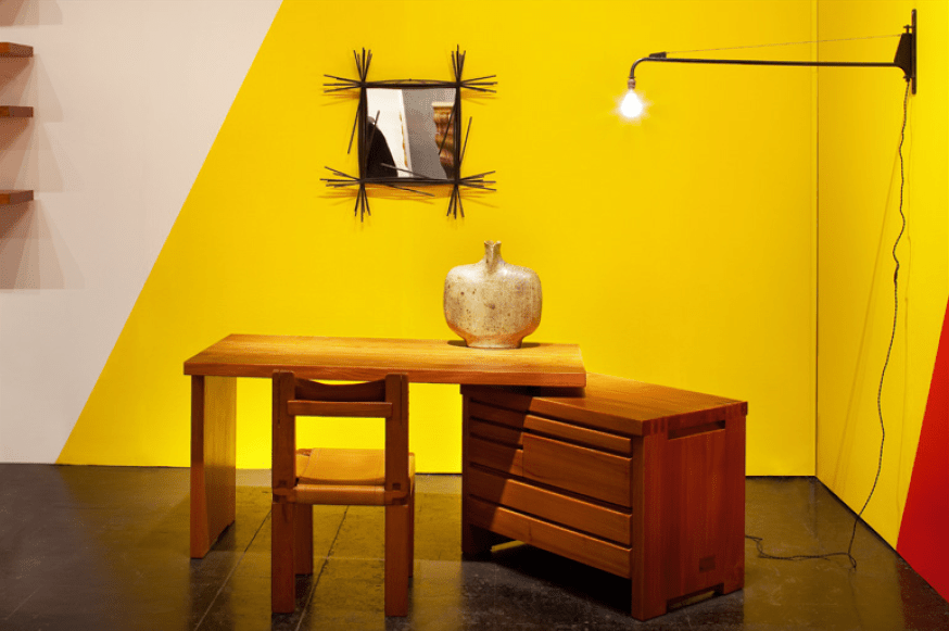 Magen H Gallery's booth at Collective Design Fair, showcasing Pierre Chapo's &quot;B19&quot; desk and &quot;S11B&quot; chair, Gustave Tiffoche's ceramic vase, Colette Gu&eacute;den black mirror, and Jean Prouv&eacute;'s Potence lamp