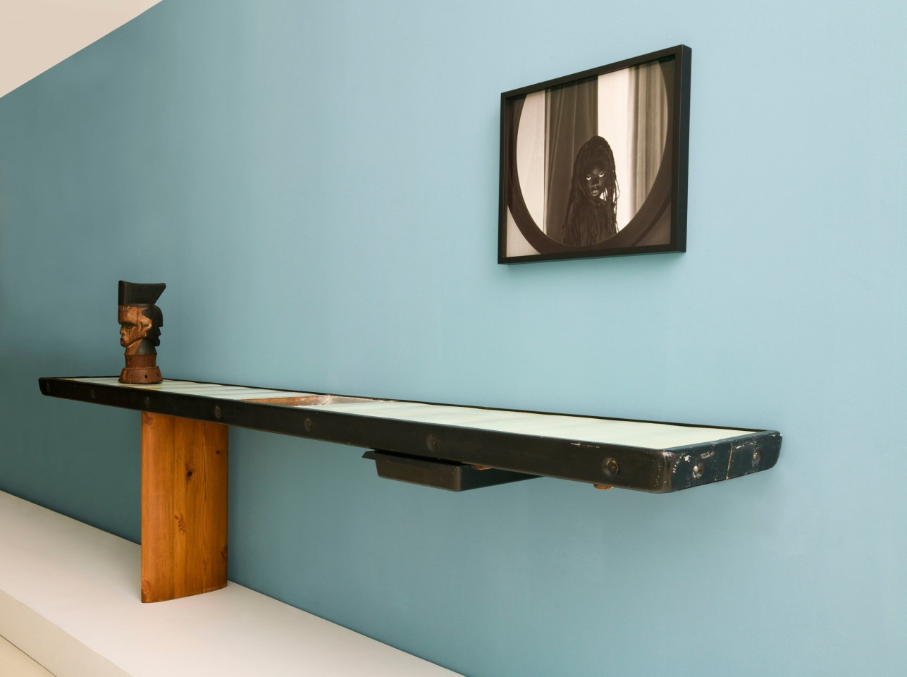 Charlotte Perriand's console (c. 1950), Idoma artist Oglinye Society wooden headcrest and Zanele Muholi's framed photograph