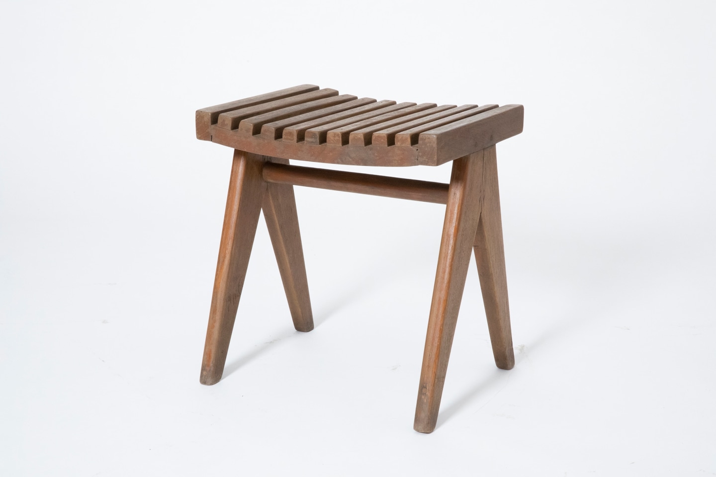 Pierre Jeanneret's pair of stools, full diagonal view of single stool from slightly above