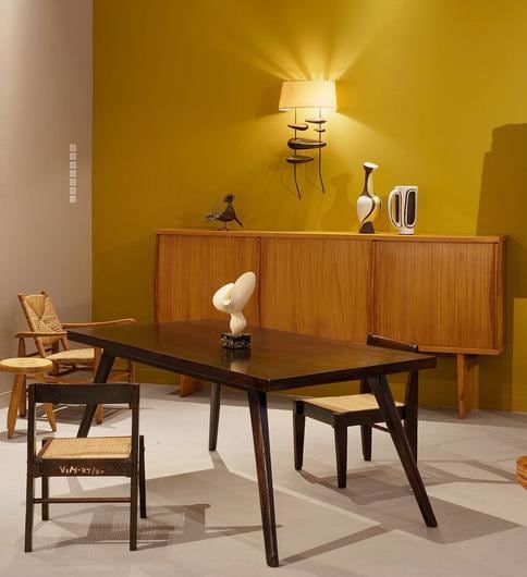 Magen H Gallery's booth at Design Miami, installation view of Pierre Jeanneret's pair of demountable chairs, Pierre Jeanneret's dining table, Antoine Poncet's sculpture, Charlotte Perriand &amp; Pierre Jeanneret's sideboard, Georges Jouve's wall sconce, Gilbert Valentin/Les Archanges' ceramic vase, and Georges Jouve's ceramic case