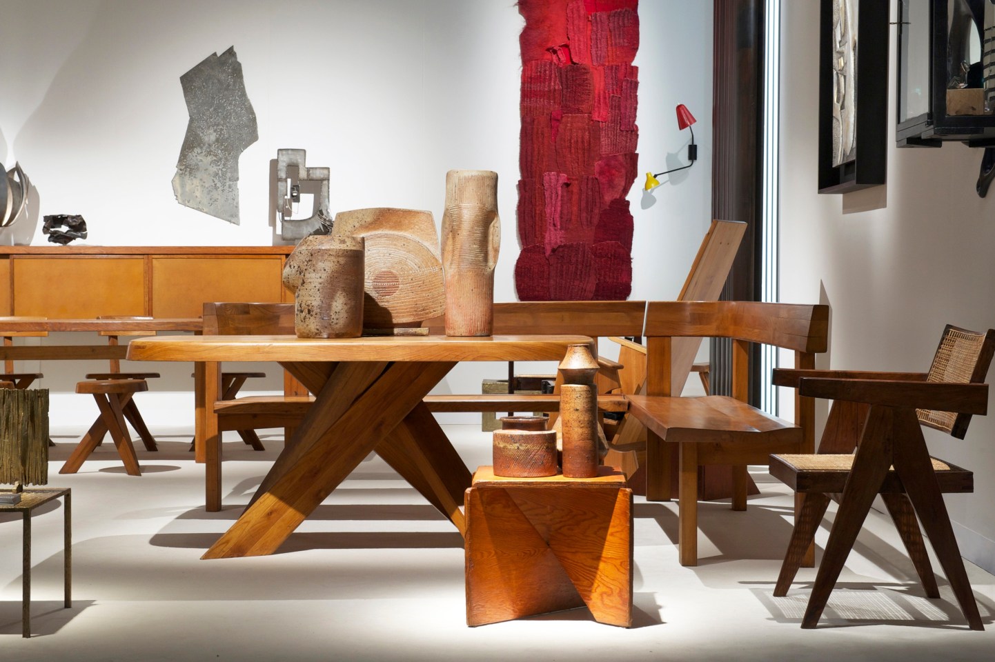 Side installation image of booth with Yves Mohy ceramic vases, Pierre Chapo's &quot;T35C&quot; dining table, and Ilina Horning's &quot;Narrabri&quot; tapestry