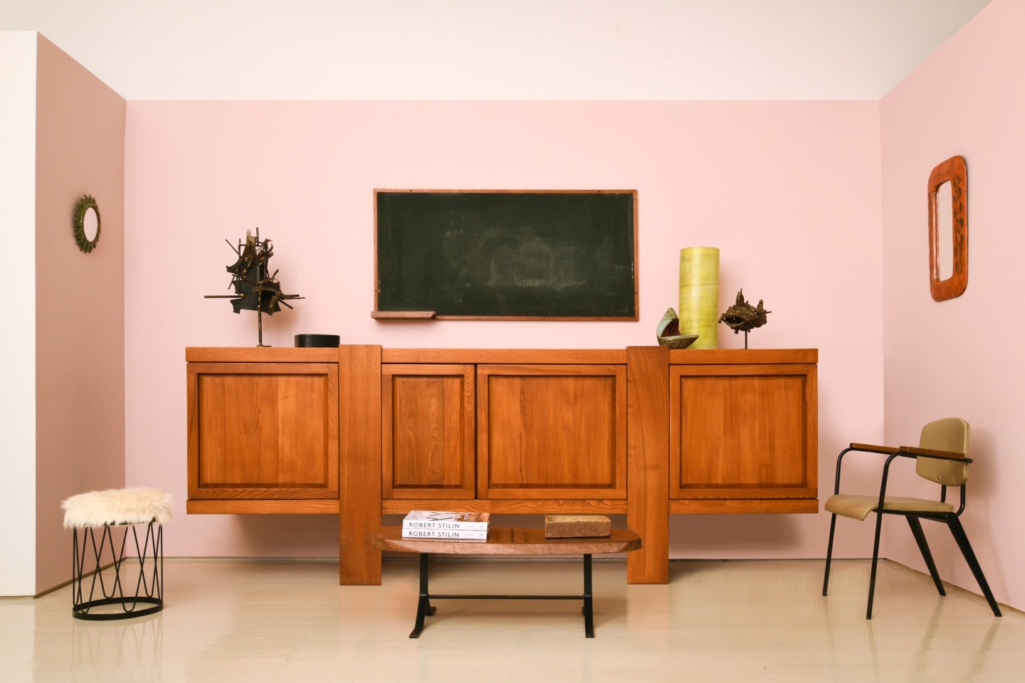 Robert Stilin's room | Pieces from left to right are Line Vautrin's &quot;Soleil a Pointes&quot; mirror (c. 1950), Attribution in the style of Royere's sool (c. 1940), French 1960/70's brutalist table lamp, Pierre Chapo's &quot;R16&quot; sideboard (c. 1976), Le Corbusier's blackboard (1959), Marolles' coffee table/bench (c. 1960), Andre-Aleth Masson's ceramic bowl (c. 1955-60), Georges Jouve's ceramic vase (c. 1950), Aglae Liberaki's bronze sculpture (c. 1960), Jean Prouv&eacute;'s Conference No 355 chair (c. 1954), and Juliette Derel's ceramic mirror (c. 1960)