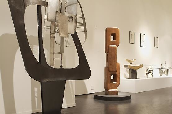 Alain Douillard exhibition at Magen H Gallery, installation view showing Douillard's sculptural mobile, wooden sculpture, chair and side tables