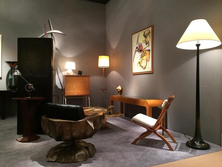 Magen H Gallery's booth at Winter Antiques Show, install image of Ren&eacute; Herbst's table lamp, Francois Gueneau's sculptural chair, Louis Sognot's secretary desk, and Paul Poiret's console, Robert Mallet Stevens' foldable chair, and a floor lamp in the manner of Paul Poiret