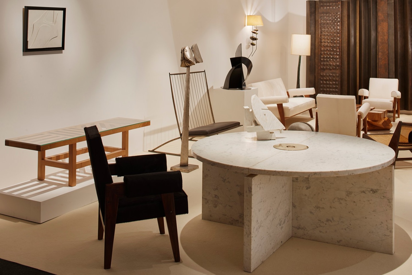 Magen H Gallery's booth at PAD London: showcasing from left to right are Sol Lewitt and Meta Memphis's coffee table, Jean Le Gros' wall sculpture, Pierre Jeanneret's &quot;Advocate and Press&quot; armchair, Christophe Gevers' circular dining table, Philolaos Tloupas' Sculptural Psyche and bench, and Pierre Sz&eacute;kely's &quot;Ange&quot; sculpture