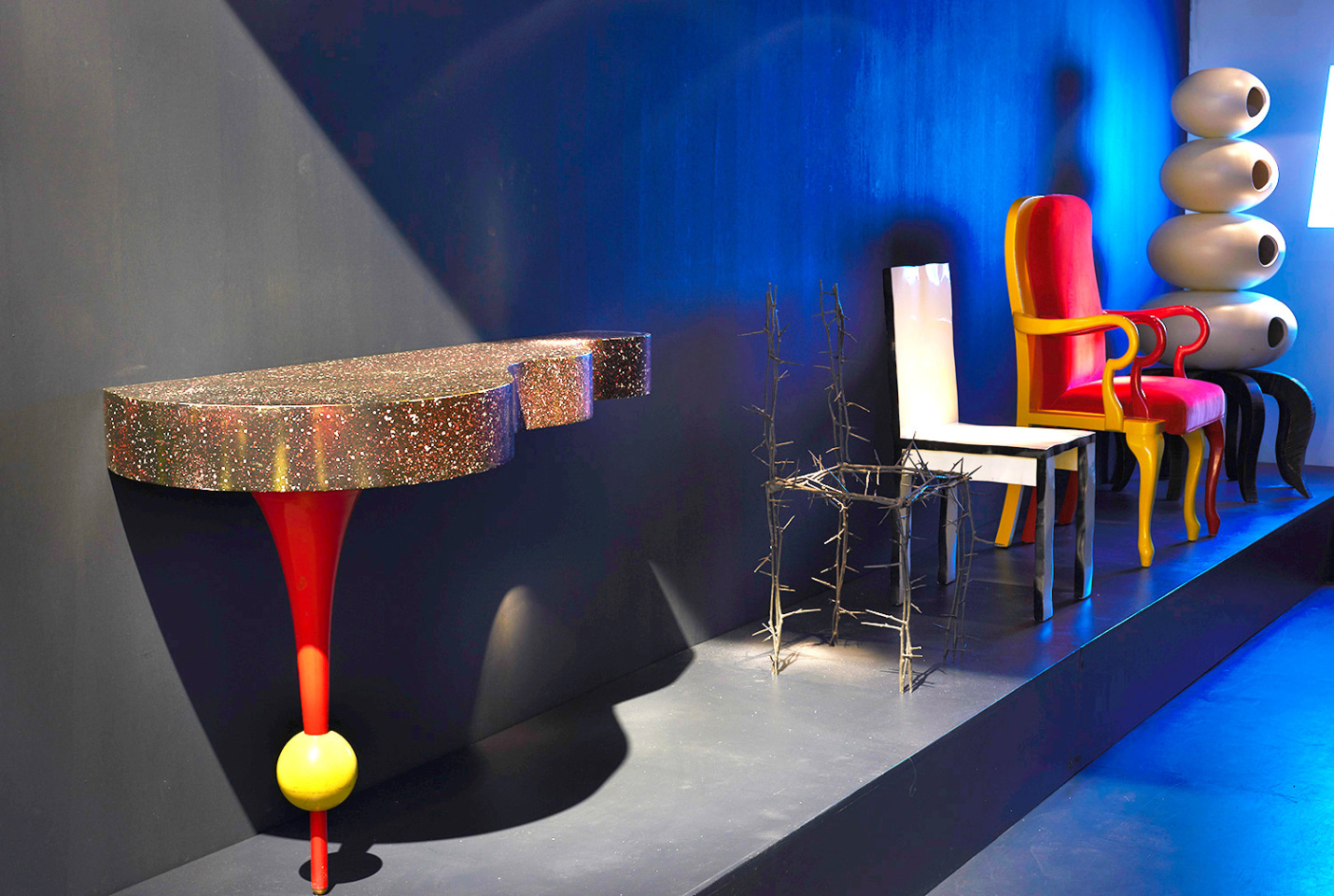 Magen H Gallery's booth Design Miami, install image of Dan Friedman's console, Michele Oka Doner's Terrible chair, Howard Meister's Designer chair, Main &amp; Main's Queen Anne, Queen Anne, and Richard Snyders' Cabinet of the Ancient Squid