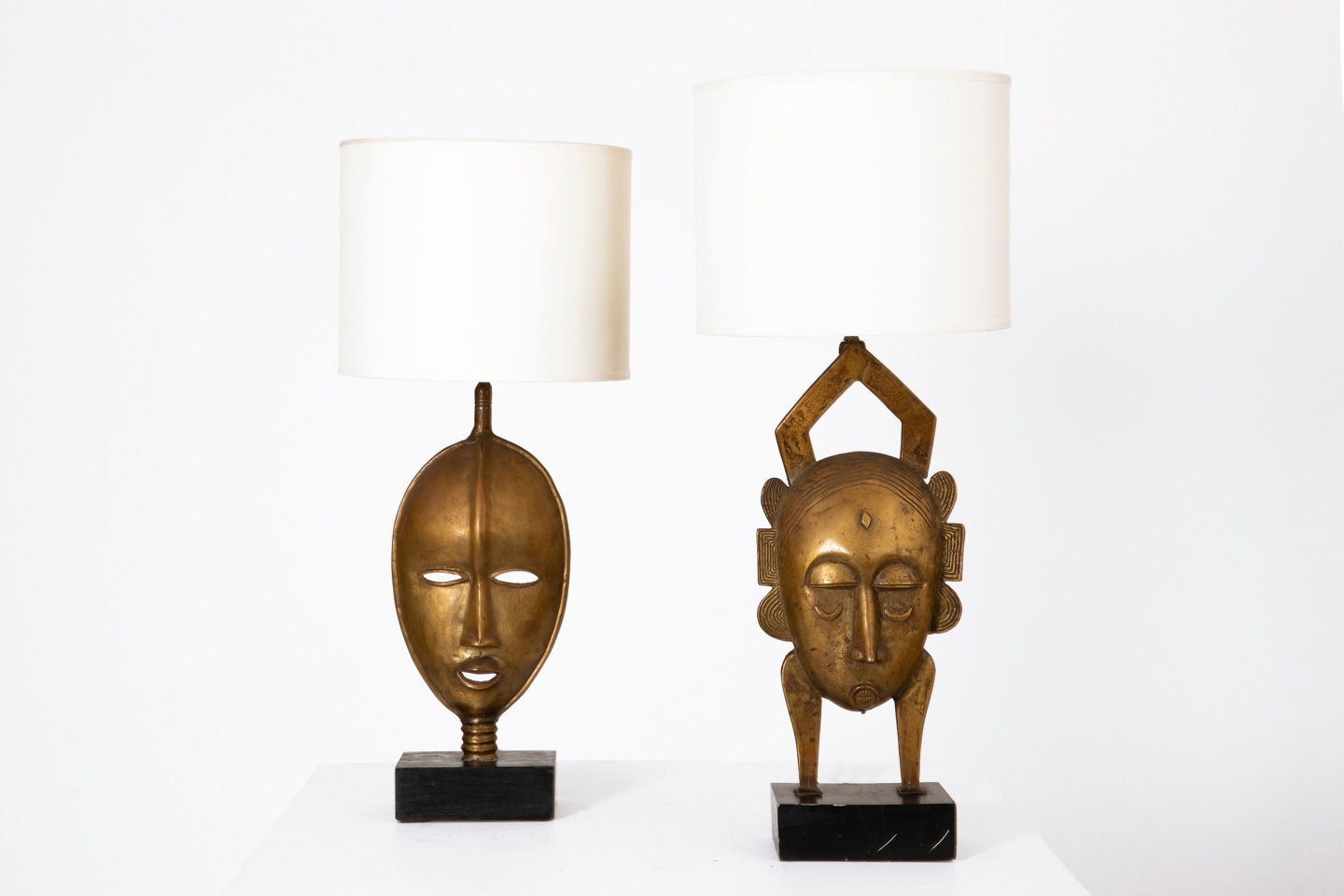 Unknown artist's pair of mask table lamps, straight front view