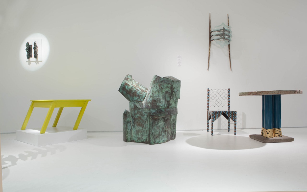 Art et Industrie exhibition installation view: Pieces from left to right are Michele Oka Doner's door handles, Rafael Barrios' Mesa table, Jim Cole's Dorset Marker, Terence Main's &quot;Amity&quot;, Paul Ludick's Apartheid Chair, and Carmen Spera's &quot;Cafe Rapido&quot; console table