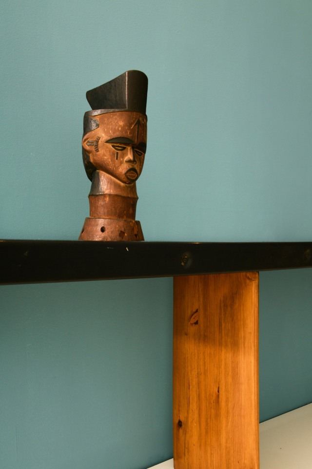 Close up view of Charlotte Perriand's console (c. 1950) and Idoma artist Oglinye Society wooden headcrest