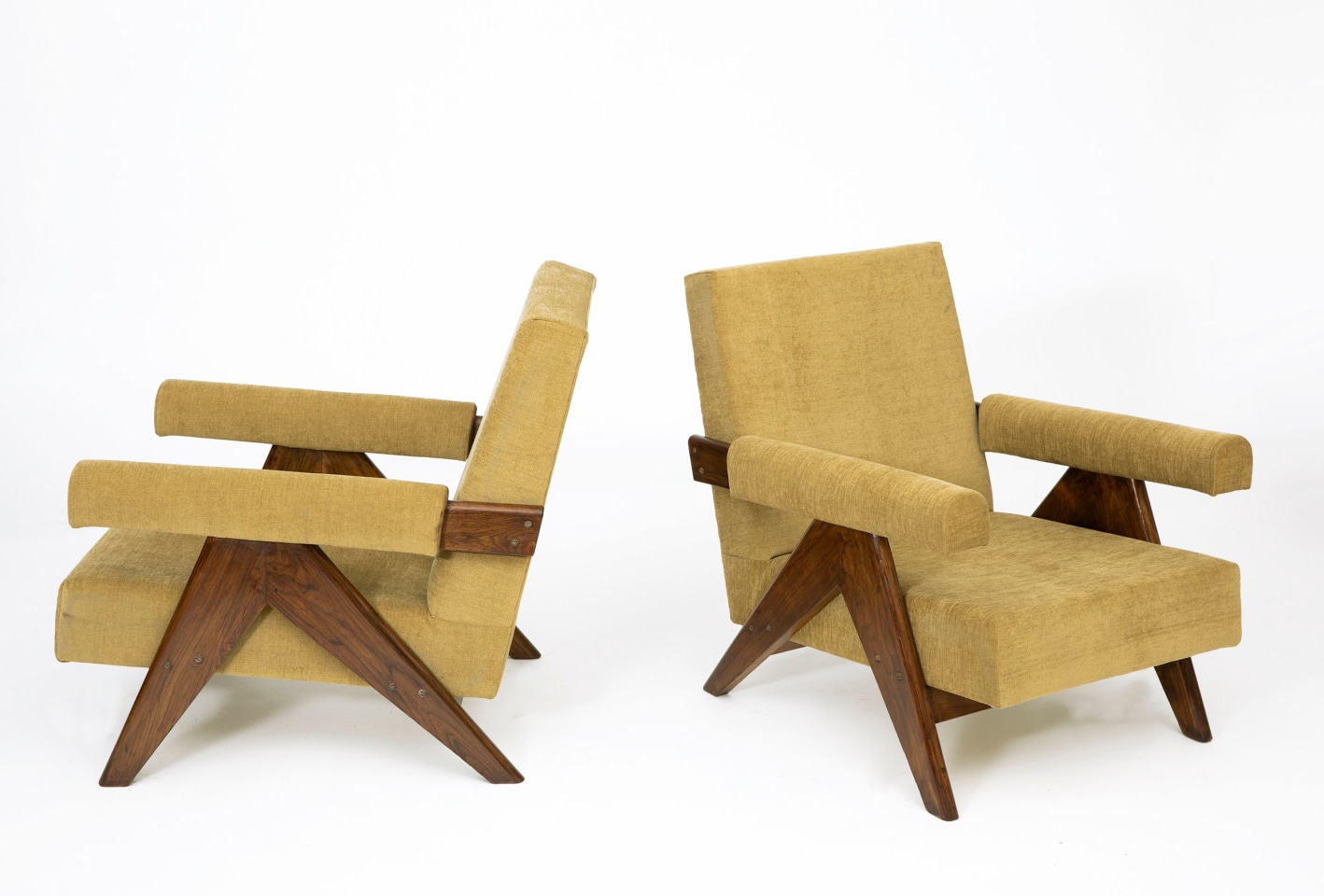 Pierre Jeanneret's Pair of &quot;Upholstered Easy&quot; lounge chairs, full side and front diagonal views