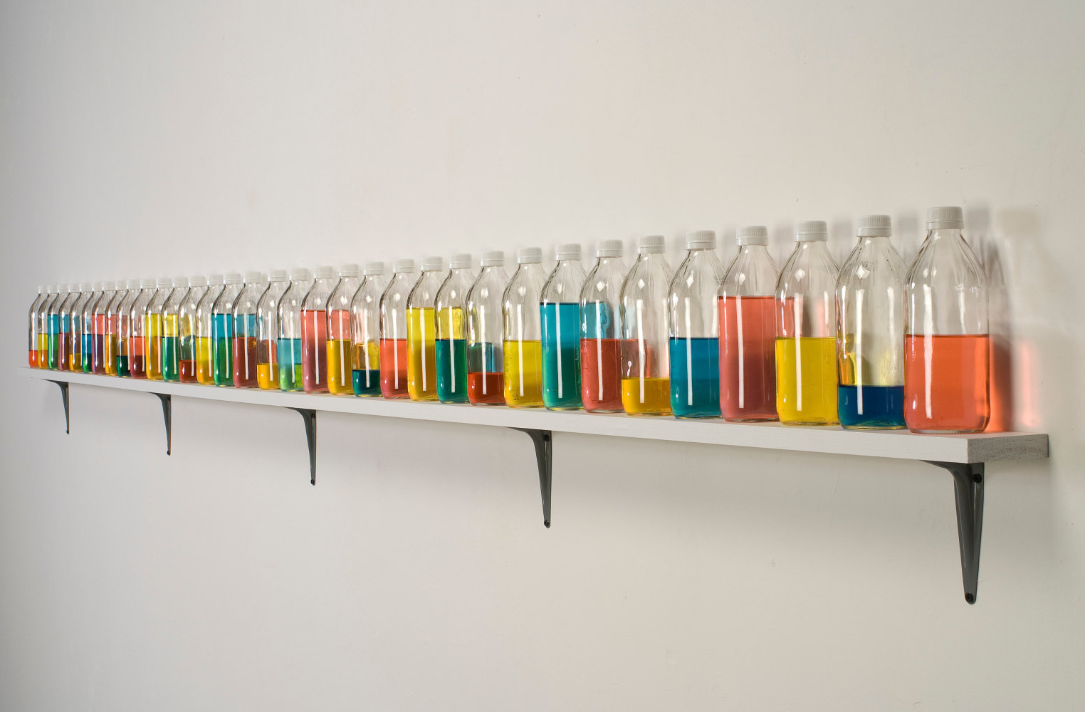 Tony Feher (Chanting One), 2008 Signed on shelf verso 34 glass bottles with screw caps, water, food color and painted wood shelf 8 1/4 x 120 1/2 x 3 1/2 inches 21 x 306.1 x 8.9 cm