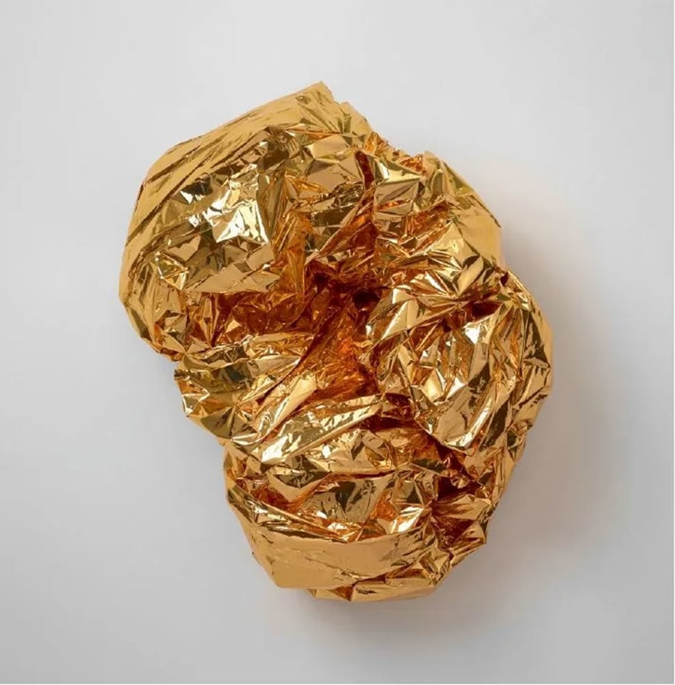 Tony Feher Calico, 2014 Gold tone mylar space blanket and binder clip 18 x 14 x 11 inches 45.7 x 35.6 x 27.9 cm