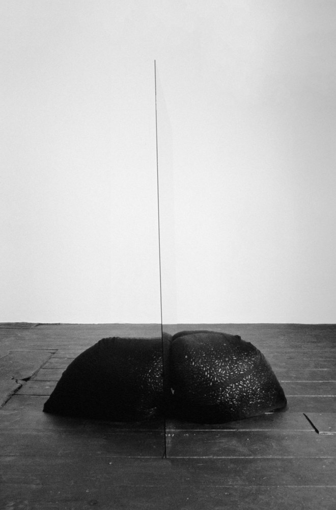 Lucia Nogueira
Untitled, 1988
Two sacks of silk organza, Brazilian black beans, glass, floor rubbed with graphite
Each sack: approx. 13 3/4 x 13 3/4 x 13 3/4 inches (35 x 35 x 35 cm)
Glass: 47 1/4 x 29 1/2 x 1/8 inches (120 x 75 x 0.3 cm)
Overall: 47 1/4 x 29 1/2 x 39 1/3 inches (120 x 75 x 100 cm)