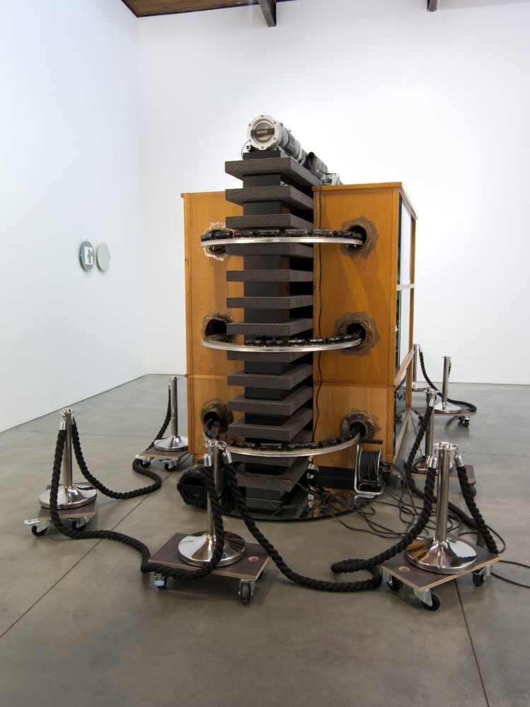 Reinhard Mucha

Straight / Edition 1991 - &amp;gt;&amp;gt;Kreuzst&amp;uuml;ck&amp;lt;&amp;lt;, [2013] 2013 / 2004

Two-part work ensemble

Sculptural room installation with sound

&amp;nbsp;

Free-standing sculpture

Straight, 2013

Stanchions, ropes, transport dollies, boomboxes with sound from daily New York local radio stations, electrical and electronic equipment, transformer, power strip, cable reel, glass mirrors, model railway (track HO), aluminum framework, glass fronted wooden cabinets (found objects), felt, &amp;ldquo;Defiant&amp;rdquo;-LED tube lamps, base tubes and heating pipes cast iron, zinc sheet, mineral wool, soil incrustations (found objects), mounting steel brackets, central element felt and black tinted glass on wooden construction

93 1/2 x 124 x 218 inches&amp;nbsp;&amp;nbsp;&amp;nbsp;

(237.49 x 553.72 x 314.96 cm)

Wall-mounted diptych

Edition 1991 - &amp;gt;&amp;gt;Kreuzst&amp;uuml;ck&amp;lt;&amp;lt;, 2004

Left tondo

metal shoulder clamps, 2 float glass discs, alkyd enamel painted on reverse of glass, book page offset print double-sided (found object), felt

&amp;oslash; 14.96 x 1.81 inches

&amp;oslash; (38.0 cm x 4.6 cm)

Right tondo

metal shoulder clamps, float glass disc, aluminum disc, felt

&amp;oslash; 13.39 x 1.81 inches&amp;nbsp;

&amp;oslash; (34.0 cm x 4.6 cm)
