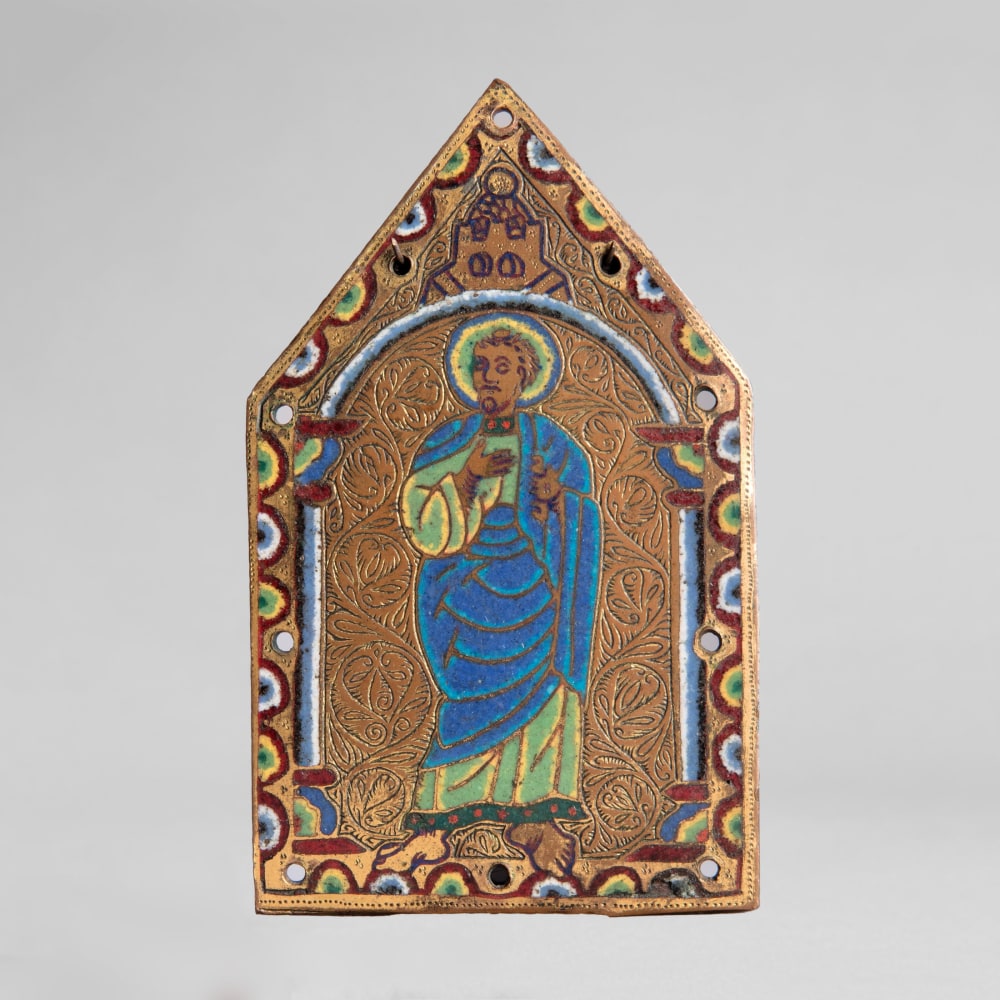 A gable plaque from a reliquary chasse showing a standing Apostle, c. 1190
France, Limoges, from the so-called Chapitre Workshop
Gilded, chased, and engraved copper with champlev&amp;eacute; enamel in blue, red, green, black, white and yellow
4 1/2 x 2 3/4 inches
(11.3 x 7.1 cm)