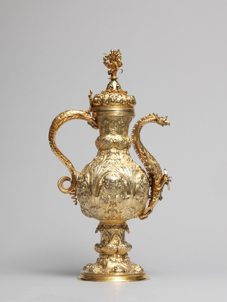 A silver-gilt ewer with dragon-headed spout and repouss&amp;eacute; ornament, c. 1500-1520
Portugal
Gilded silver with inset reverse-glass painting
19 3/4 (height) x 6 3/4 (diameter) x 10 3/8 (depth including handle and spout) inches
(50.3 x 17.2 x 26.5 cm)
2 kilograms gross wight