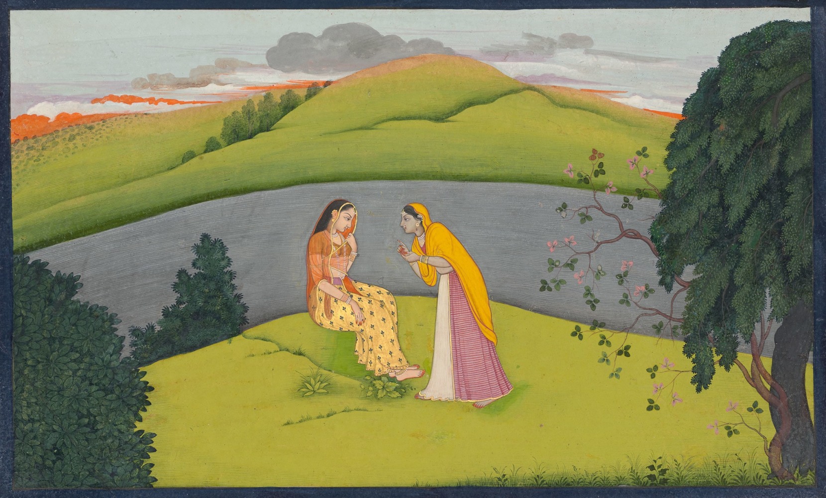 The sakhi describes Krishna&amp;rsquo;s lovelorn state to a hesitant Radha, 1765-70
Folio from the &amp;lsquo;Second Guler&amp;rsquo; or &amp;lsquo;Tehri-Garhwal&amp;rsquo; Gitagovinda
Master of the first generation after Manaku and Nainsukh of Guler
Tempera, opaque pigments on paper, with gold pigment
Folio: 6 7/8 x 10 7/8 inches (17.6 x 27.5 cm)
Painting: 6 1/8 x 10 1/8 inches (15.3 x 25.7 cm)