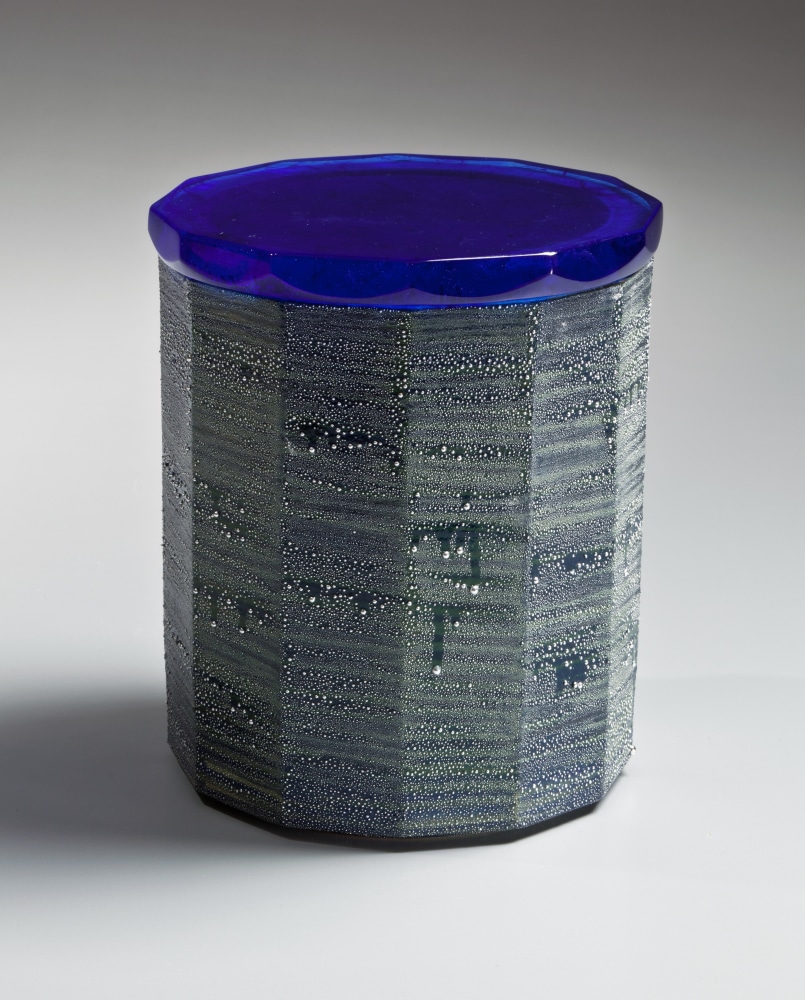 Faceted water jar with cobalt blue glaze, turquoise blue interior, and &amp;quot;silver mist&amp;quot; over-glaze with a cast glass lid

2015

Glazed porcelain and cast glass cover&amp;nbsp;&amp;nbsp; &amp;nbsp;

6 3/4 x 5 5/8 x 5 5/8 in.