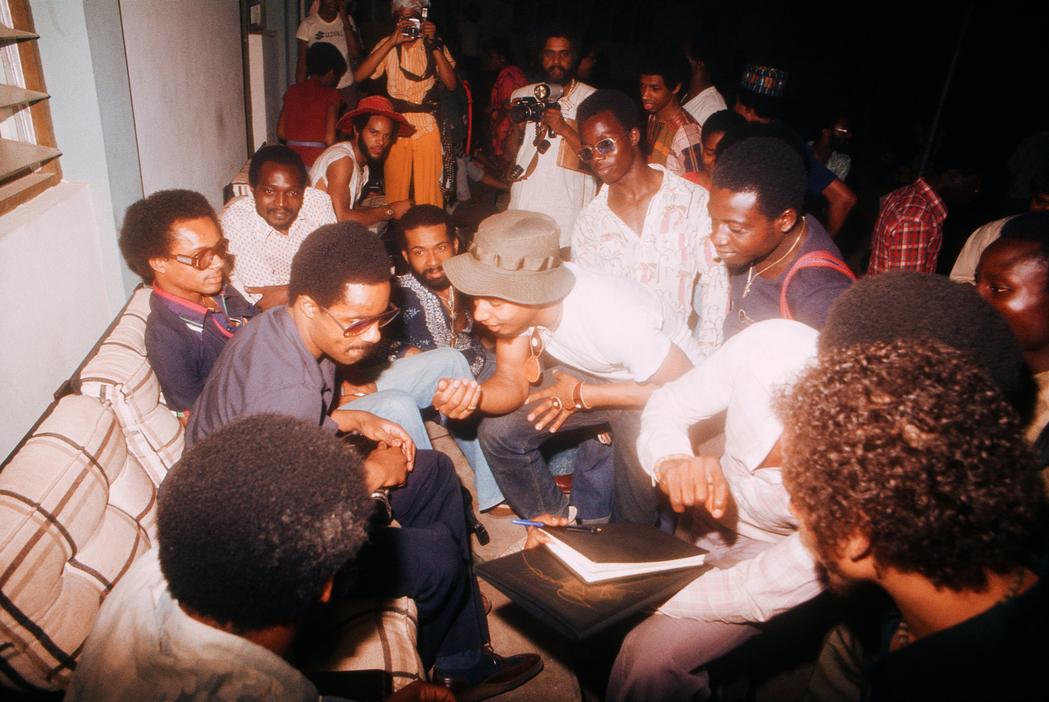 Roy Lewis (b. 1937)
Stevie Wonder Visiting FESTAC Village, 1977
Archival inkjet print on Simply Elegant Gold Fibre paper
Image: 13 3/4 x 20 inches (34.9 x 50.8 cm)
Sheet: 17 x 22 inches (43.2 x 55.9 cm) Framed: 18 5/8 &amp;times; 25 3/8 &amp;times; 1 1/2 inches (47.3 &amp;times; 64.5 &amp;times; 3.8 cm)
Edition of 5, printed 2023