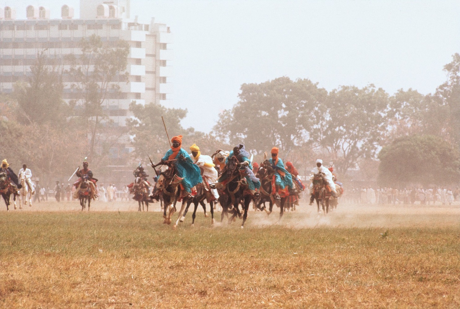 Roy Lewis (b. 1937)
Durbar Horsemen Charge the Stands, 1977
Archival inkjet print on Simply Elegant Gold Fibre paper
Image: 13 3/4 x 20 inches (34.9 x 50.8 cm) Sheet: 17 x 22 inches (43.2 x 55.9 cm)
Framed: 18 5/8 &amp;times; 25 3/8 &amp;times; 1 1/2 inches (47.3 &amp;times; 64.5 &amp;times; 3.8 cm)
Edition of 5, printed 2023