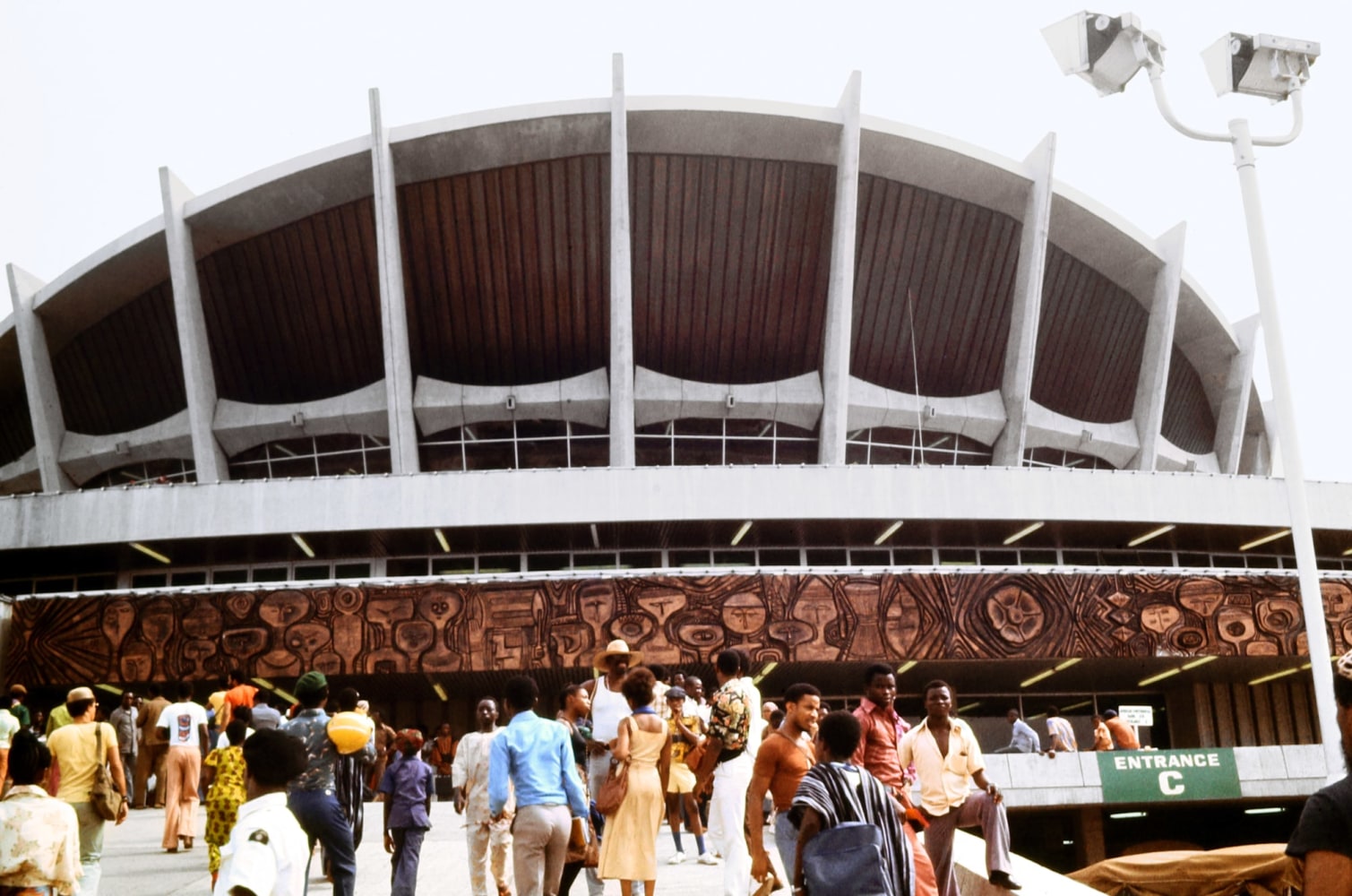 K. Kofi Moyo (b. 1939)
National Theater Lagos, Nigeria venue of Indoor Events, 1977
Archival inkjet print on Simply Elegant Gold Fibre paper&amp;nbsp;
Image: 13 1/4 x 20 inches (33.7 x 50.8 cm)
Sheet: 17 x 22 inches (43.2 x 55.9 cm)
Framed: 18 5/8 &amp;times; 25 3/8 &amp;times; 1 1/2 inches (47.3 &amp;times; 64.5 &amp;times; 3.8 cm)
Edition of 1, printed 2023