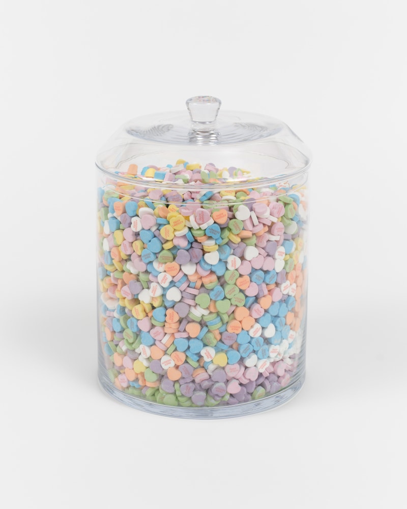 A glass jar filled with heart shaped candies that read &quot;Enjoy Diversity”