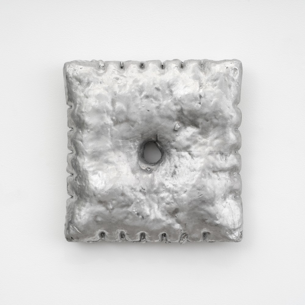A large aluminum cast Cheezit cracker mounted to the wall