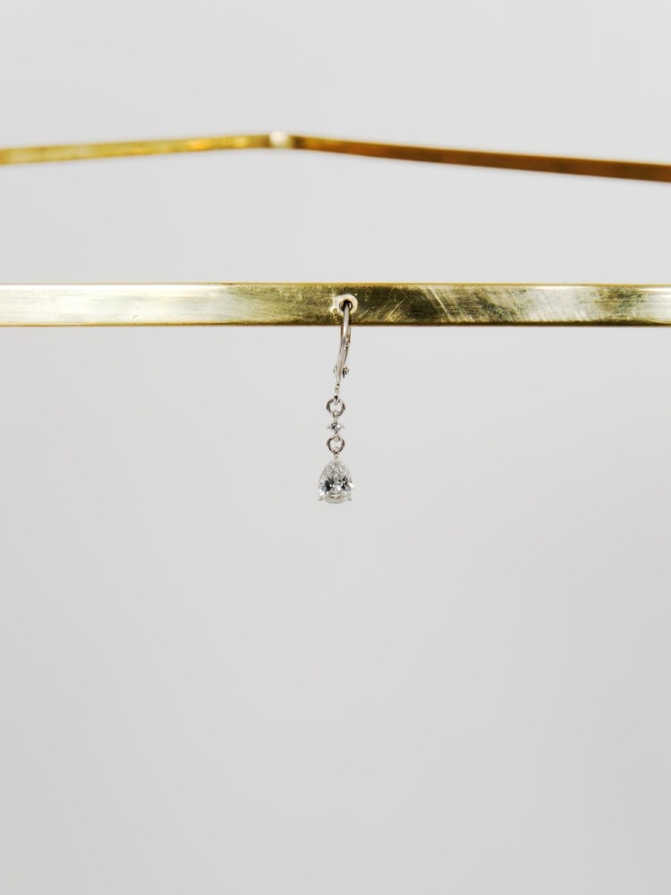 Tania Pérez Córdova, We focus on a woman facing sideways, 2013–16. Bronze, Swarovski Crystal Drop earring, and a woman wearing the other earring; 36 × 18 in.