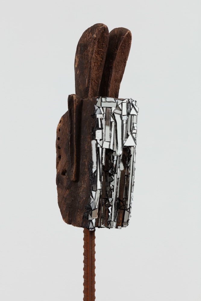 Kader Attia
Mirror Mask (detail)
2020
Wooden mask, mirror fragments, black pigment
Artwork Dimensions:
18 1/8 x 7 x 6 5/8 inches (46 x 18 x 17 cm)
Overall Dimensions:
77 x 10 x 10 inches (195.6 x 25.4 x 25.4 cm)