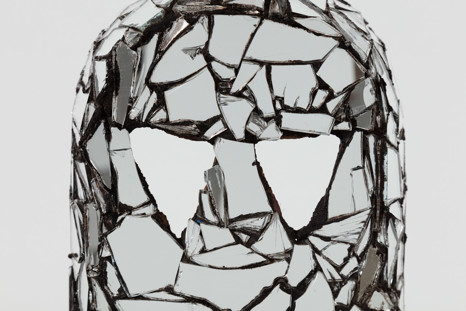 Kader Attia
Mirror Mask (detail)
2020
Wooden mask, mirror fragments, black pigment
Artwork Dimensions:
17 1/2 x 6 x 6 1/2 inches (44.5 x 15.2 x 16.5 cm)
Overall Dimensions:
75 1/4 x 10 x 10 inches (191.1 x 25.4 x 25.4 cm)