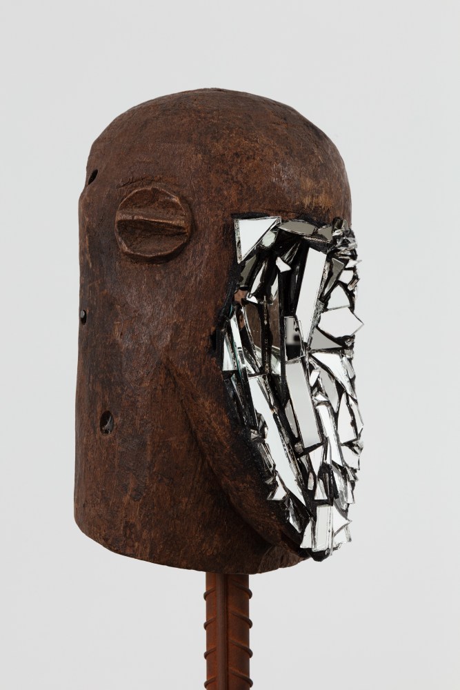 Kader Attia
Mirror Mask&amp;nbsp;(detail)
2020
Wooden mask, mirror fragments, black pigment
Artwork Dimensions:
11 3/4 x 6 5/8 x 5 1/2 inches (30 x 17 x 14 cm)
Overall Dimensions:
70 x 10 x 10 inches (177.8 x 25.4 x 25.4 cm)